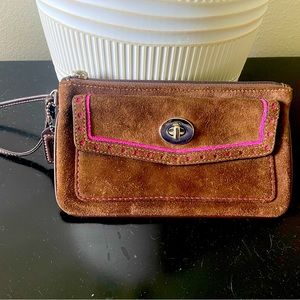 Brown coach wristlet with hot pink interior